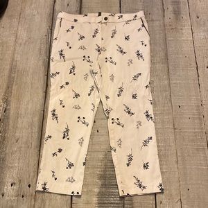 White pants with floral print in blue with navy accents.